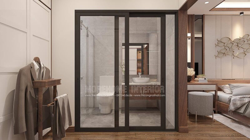 Thiết kế nội thất phòng ngủ khép kín với xu hướng mở khi sử dụng tấm ốp tường gỗ óc chó như tạo ranh giới phân chia cùng thiết kế cửa kính trượt. Thiết kế phòng ngủ biệt thự